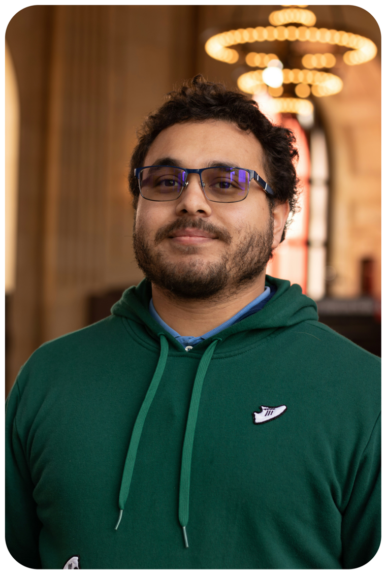 Samuel, persona headshot: a man in his mid-thirties in a green hoodie.